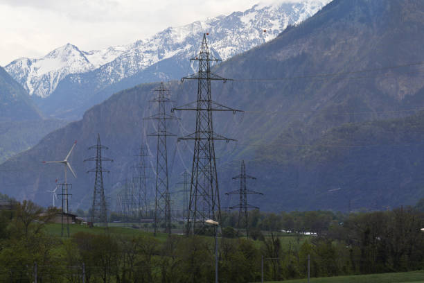istock Power pylons and wind turbines 1060389438