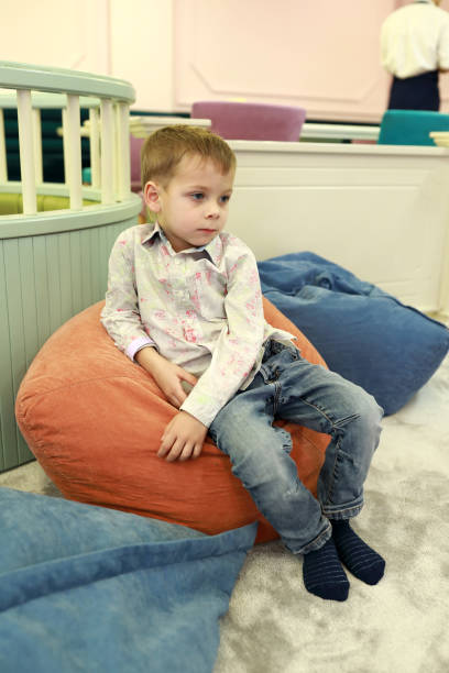 istock Child sitting on bean bag chair 1060390532