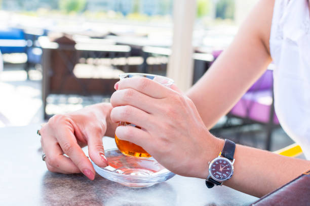 business woman in a summer cafe drinking tea