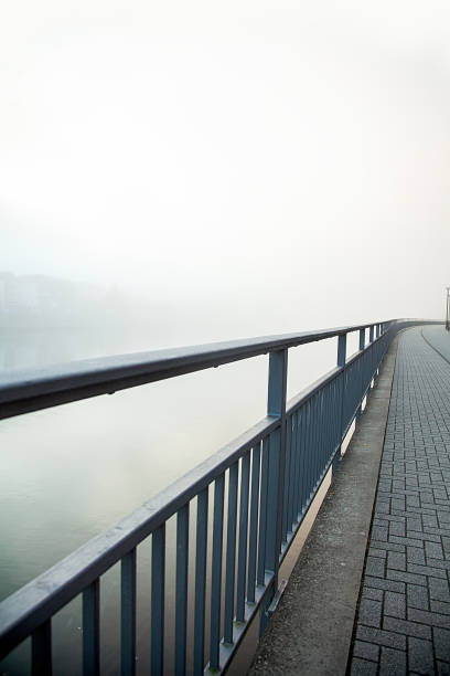 istock black bridge with paving stone in a fog 1060392928