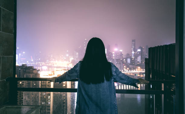 istock Young woman looking city night 1060396556