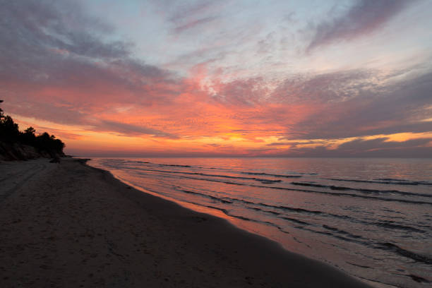 Purple orange sunset Baltic Sea and surf in autumn stock photo