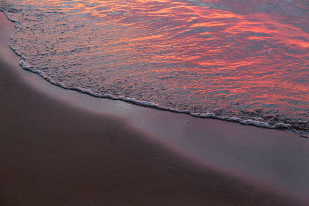 Purple orange sunset Baltic Sea and surf in autumn stock photo