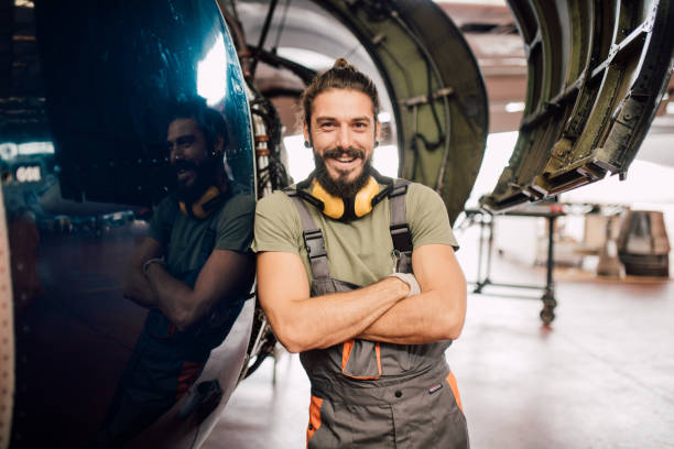 istock Happy young man in airplane hangar 1060400410