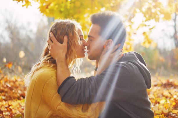 istock Young couple in love in autumn forest 1060402462