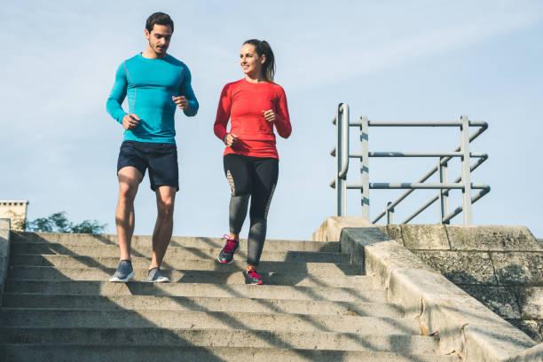 istock Fitness couple running down the steps 1060403060