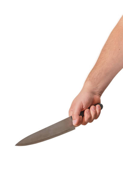istock An outstretched hand holds a large knife. 1060403168