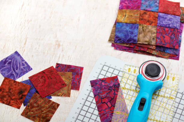 quilting tools, sliced square bright pieces of batik, stack sewn blocks - patch textile stack heap imagens e fotografias de stock