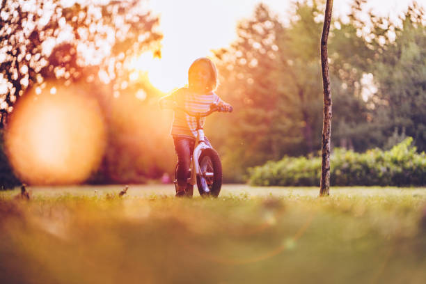 istock Cute boy riding a bike in park 1060407704
