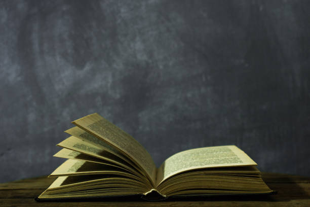 istock Old books on a oak wooden table. Beautiful dark background. 1060419494