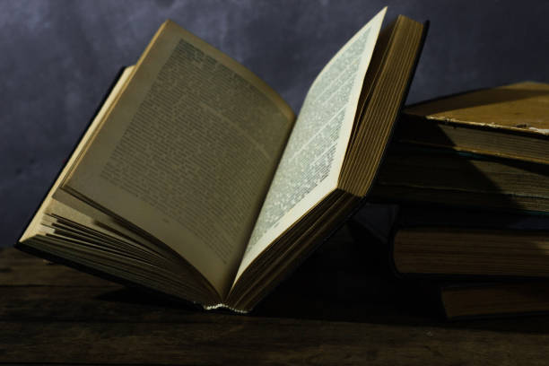 istock Old books on a oak wooden table. Beautiful dark background. 1060419918