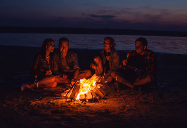 istock young friends have picnic with bonfire on the beach 1060426154