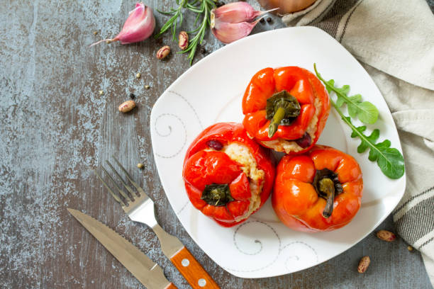 istock Stuffed Pepper with Rice, Tomatoes and Beans on a stone or concrete background. Vegetarian Healthy Food. Top view flat lay background. 1060429404