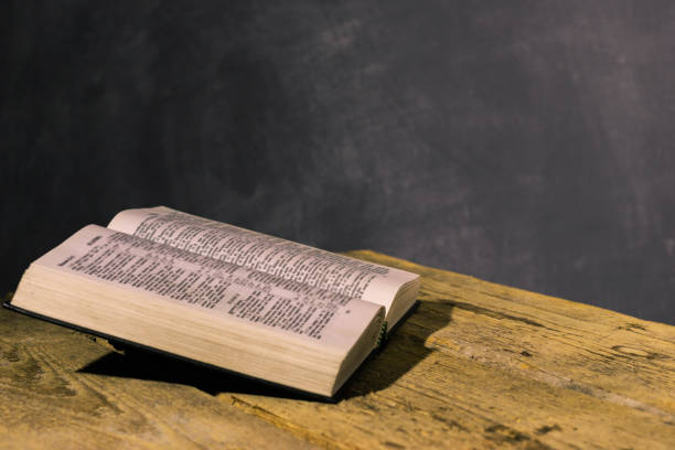 istock Bible on a old wooden table.  Beautiful dark background.Religion concept. 1060430142