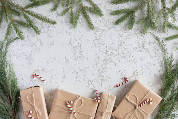istock Christmas Present holiday boxes and spruce branches on vintage white background, top view. New year flat lay 1060431974