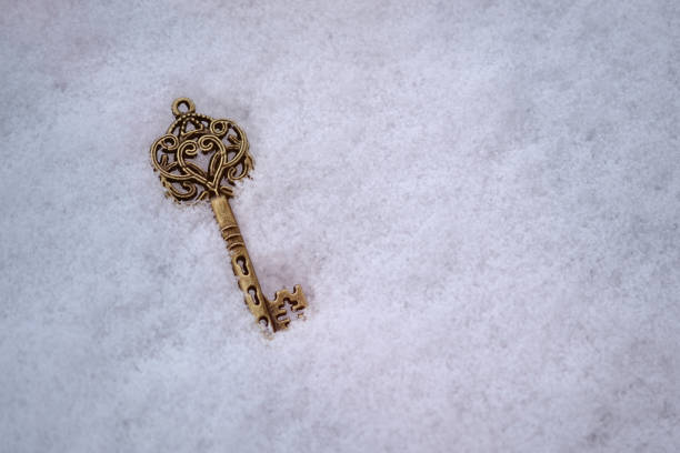 old antique beautiful key lying in the snow