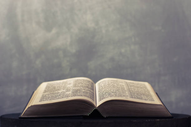 istock Bible on a round dark table. Beautiful background.Religion concept. 1060434920