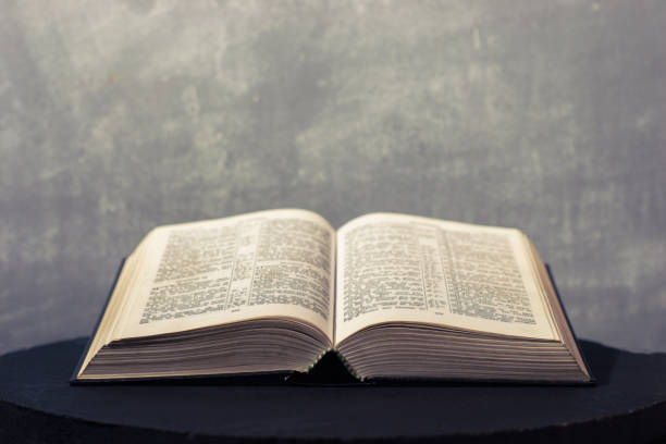 istock Bible on a round dark table. Beautiful background.Religion concept. 1060435022