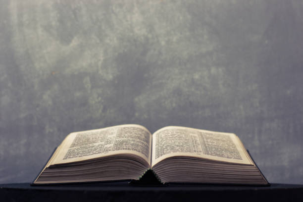 istock Bible on a round dark table. Beautiful background.Religion concept. 1060435082
