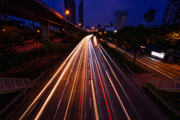 istock abstract light tails on twilight time and urban cityscape - can use to display or montage on product 1060435270