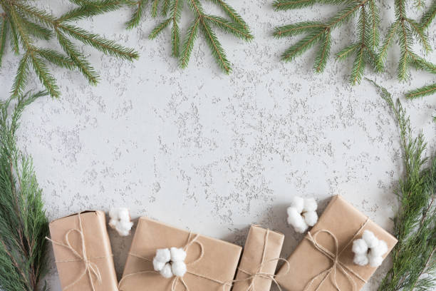 istock Christmas Present holiday boxes and spruce branches on vintage white background, top view. New year flat lay 1060435546