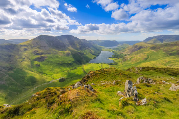 Fleetwith Pike summit overlooking Buttermere Fleetwith Pike summit overlooking Buttermere, Cumbria, England keswick stock pictures, royalty-free photos & images