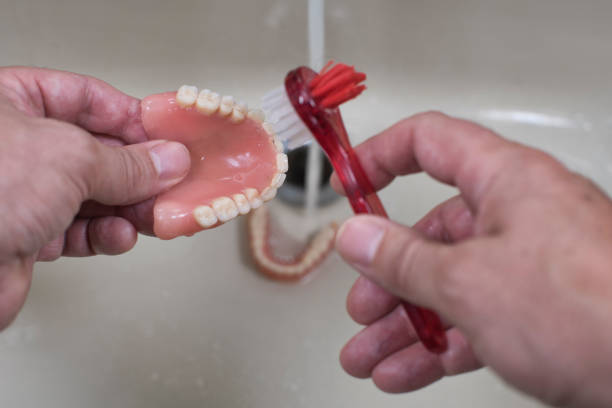 denture cleaning with brush - fotografia de stock