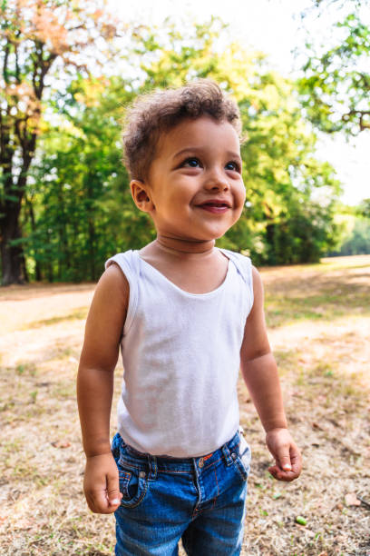 istock Happy or afro boy child smiling in park 1060440714