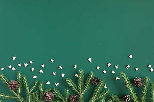 Christmas tree branch frame on green background with copy space