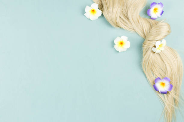 istock Hair extensions on blue wooden background. Top view 1060447494