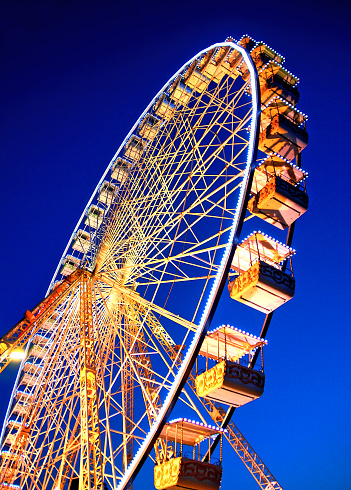 Circular carousel with nacelles in the blue of the night.