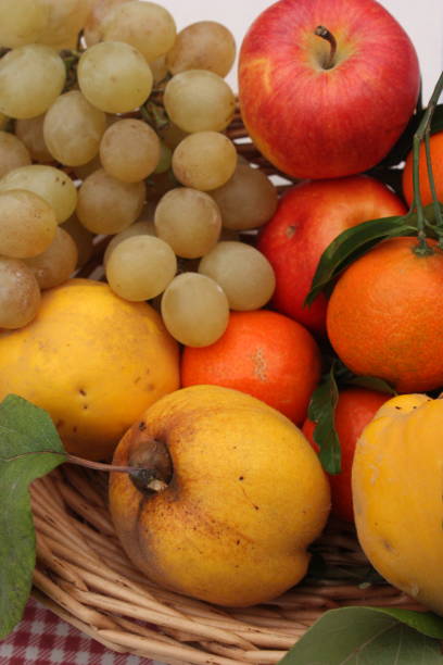 istock Basket of autumn fruit Quince Apples Grape white Mandarin 1060454356