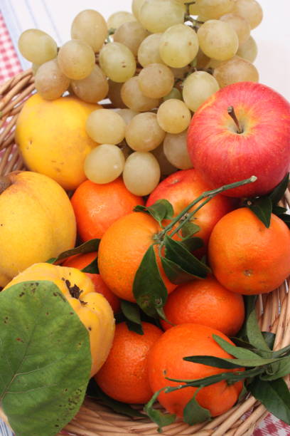 istock Basket of autumn fruit Quince Apples Grape white Mandarin 1060454412