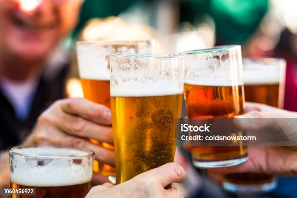 Cheers Celebration Toast With Pints Of Beer Stock Photo - Download Image Now - Beer - Alcohol, Celebratory Toast, Drinking