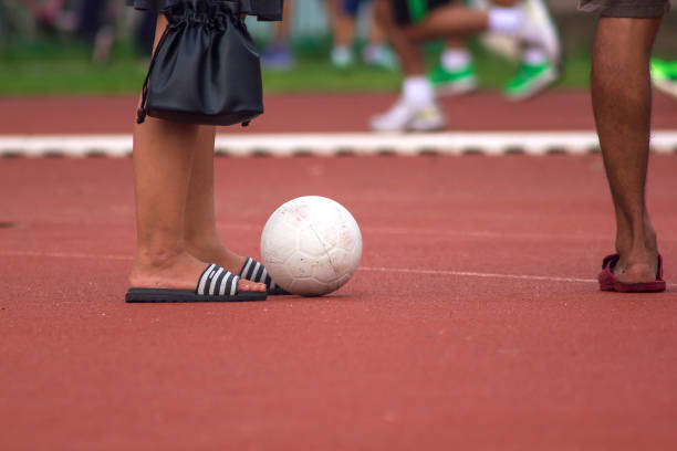 istock Men's Legs with White Soccer Ball 1060457106