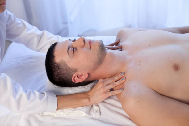 istock man doing medical massage hands person in Spa 1060466654