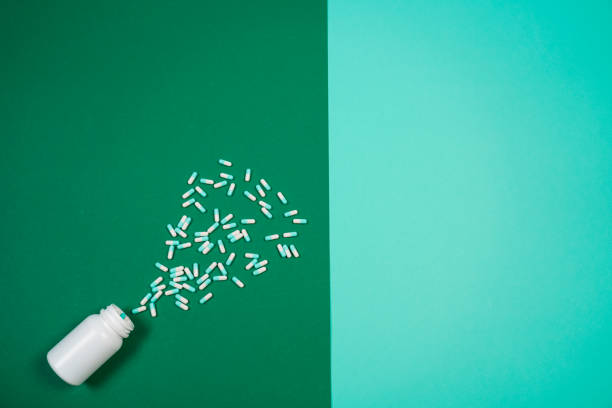 istock Pharmaceutical medicine pills, capsules and bottle on colored background. 1060467898