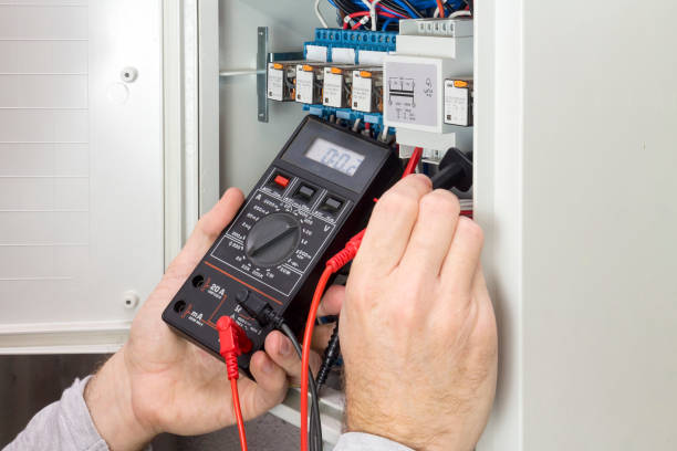 istock electrician at work measures the electric current 1060469118