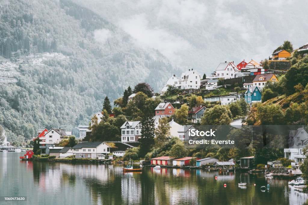 Odda city houses in Norway Landscape foggy mountains and water reflection Norway Stock Photo