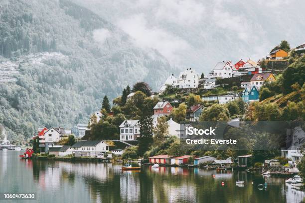 Odda City Houses In Norway Landscape Foggy Mountains And Water Reflection Stock Photo - Download Image Now