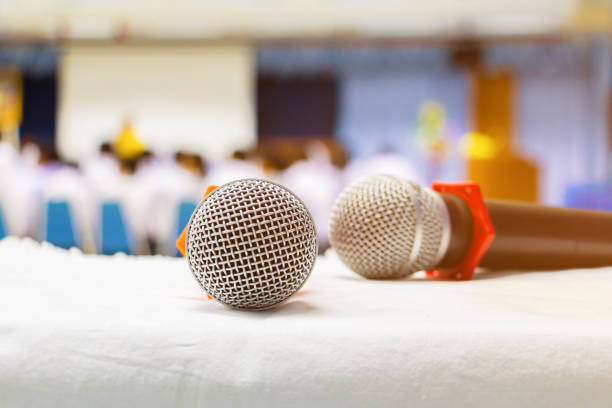 istock Close up old microphone wireless two on the white table in business conference interior seminar meeting room and Background blur 1060473836