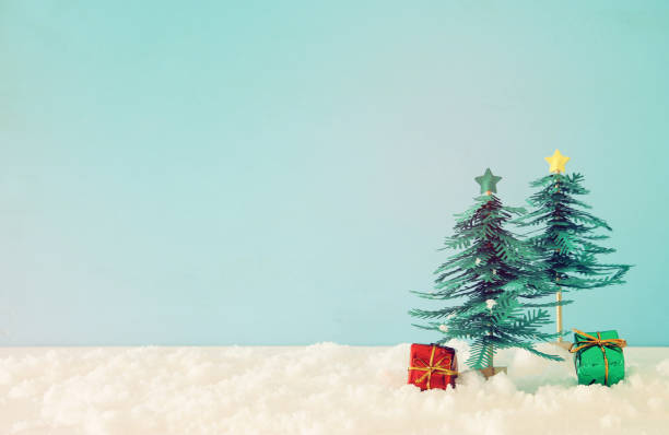 istock Image of paper christmas trees over white snow. 1060474724