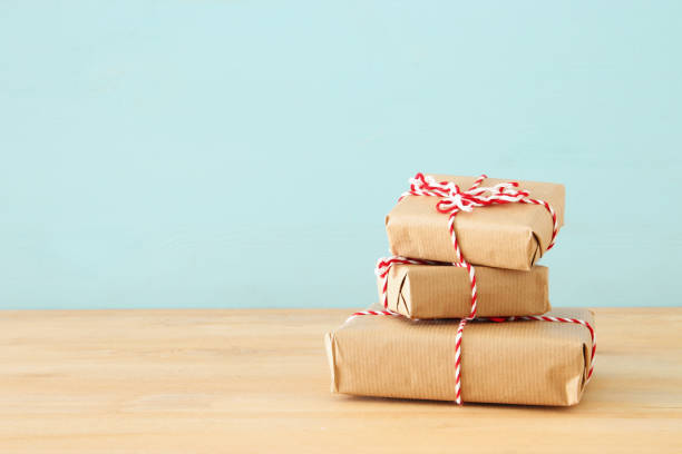 istock image of handmade wrapped gift boxes over wooden table. 1060474760