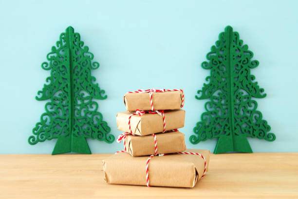 istock image of handmade wrapped gift boxes over wooden table. 1060474762