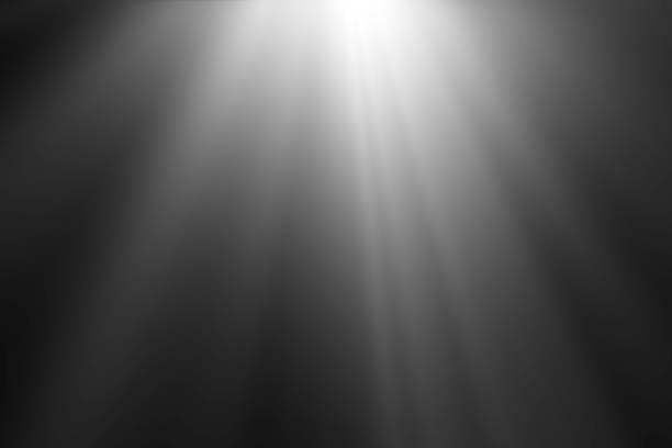 istock abstract beautiful beams of light, rays of light screen overlay on black background. 1060476896