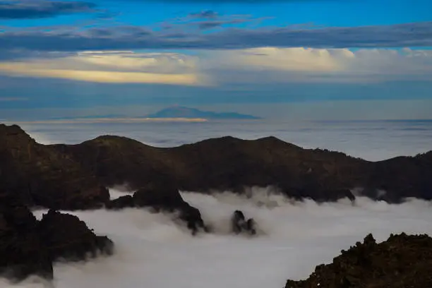 Pico de teide on tenerife behind a sea of clouds; Seen from the top of roque de los muchachos on La Palma