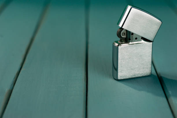 istock Gasoline lighter , white plastic lighter on a wooden background 1060479580