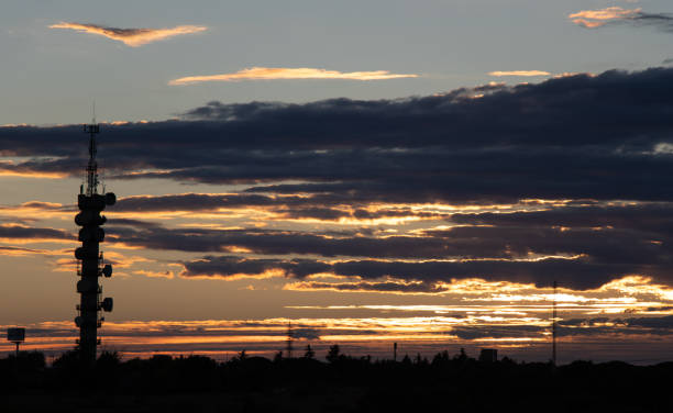 istock Back light of sunset in front of antenna with cloudy sky 1060480860