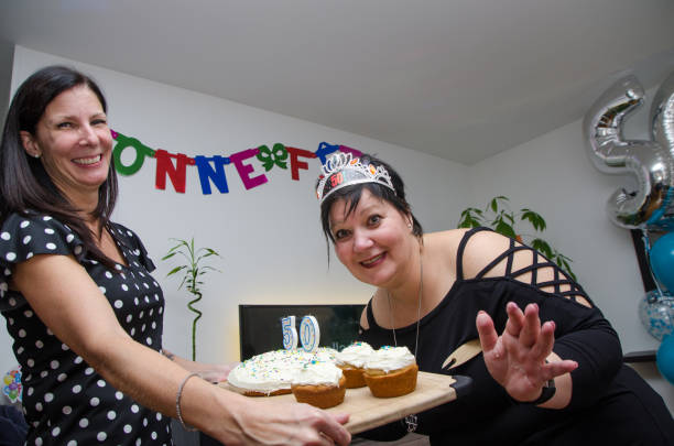 istock Two women showing 50th birthday cake 1060490984