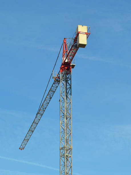 istock Tall construction tower crane against the blue sky on a day 1060491588
